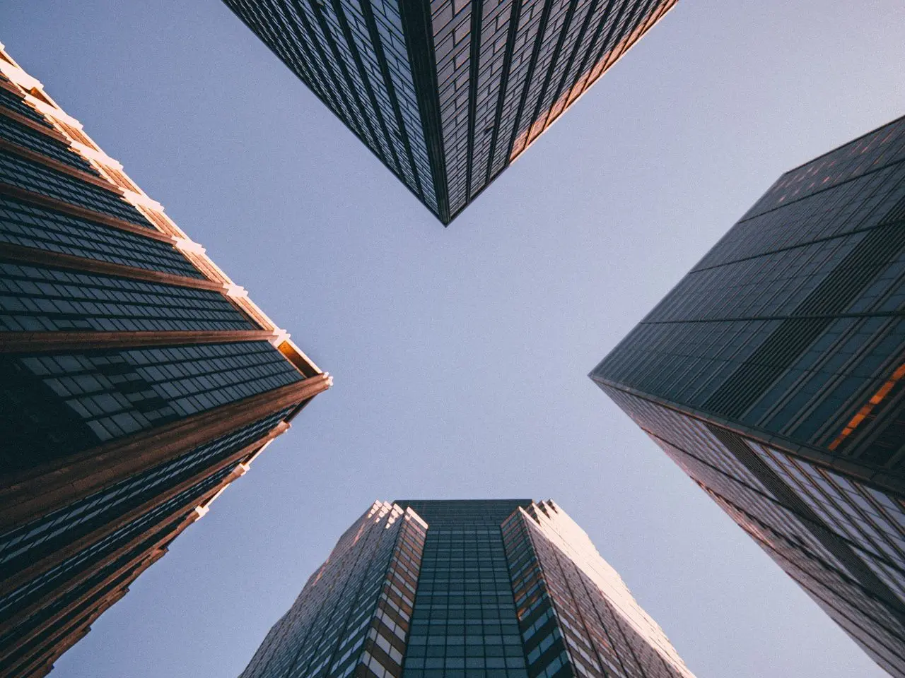 low-angle photography of four high-rise buildings